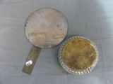 two pie pans sitting on a table with a spatula