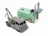 two toy trucks that are next to each other on a white surface
