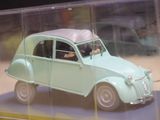 a small toy car in a clear box on a table