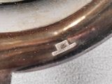 a close up of a silver plate with a spoon on it