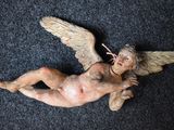 a statue of an angel on a black carpet