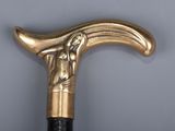 a close up of a gold colored cane with a bird on it