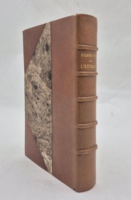 an old book with a brown cover sitting on top of a white surface