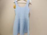 a light blue dress hanging on a hanger in a room