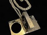 a close up of a metal object with a chain on a black background