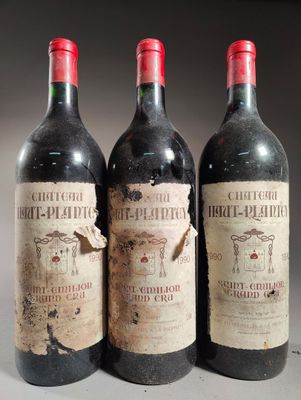 trois bouteilles de vin rouge posées côte à côte sur une table