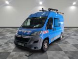 the blue van is parked on a checkered floor in the garage