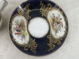 a plate with a saucer and a teapot on it