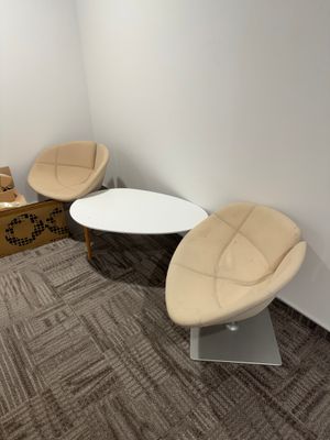 three chairs and a table in the corner of a room