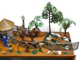 toy figurines of animals and people on a wooden table