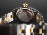 a close up of a watch with a red second hand