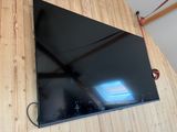 the flat screen tv is hanging on the wall in the room