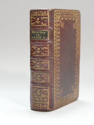 an old book sitting on top of a white surface