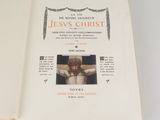 an open book with a picture of jesus on the cross