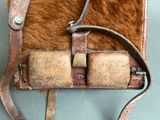 a brown and tan bag with a leather handle