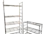 two metal shelvings and a table with a shelf