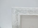 an image of a white picture frame sitting on top of a table