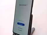 the back of a phone with a blue button on the display