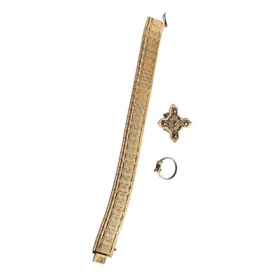 a close up of a gold bracelet with a cross on it