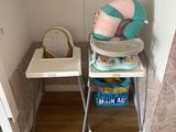 a baby ' s high chair in the corner of the room