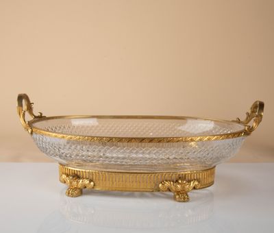 an image of a gold and crystal bowl sitting on a table