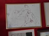 a red wall with a bunch of drawings on it