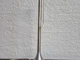 a close up of a metal table lamp on a wooden table