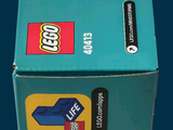 a box of legos sitting on a blue surface