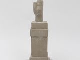 statue of a hand with a finger up on a pedestal