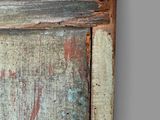 a close up of an old wooden door with peeling paint on it
