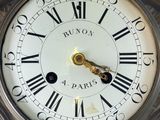 a close up of a clock with roman numerals on it