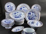 a group of blue and white plates and cups on a table