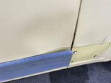 a close up of a car door with a blue strip on it