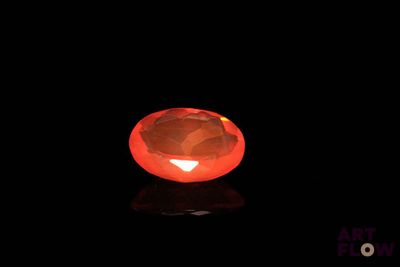 a close up of a red diamond on a black surface