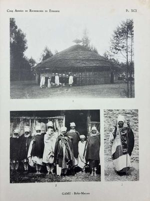 an old black and white photo of a group of people standing in front of a hut