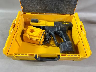 une boîte à outils jaune contenant des outils, posée sur une table
