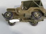 three toy army vehicles are sitting on a white surface