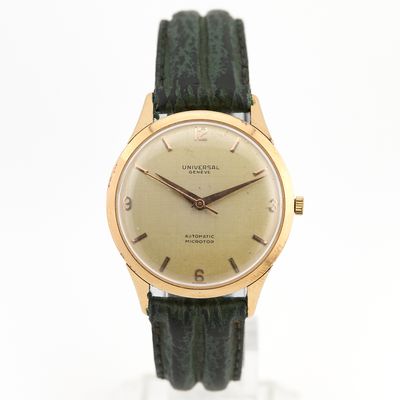 une photo d'une montre-bracelet en or avec un bracelet en cuir vert