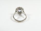 a close up of a diamond ring on a white surface