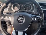 steering wheel of a car with a clock on the dashboard