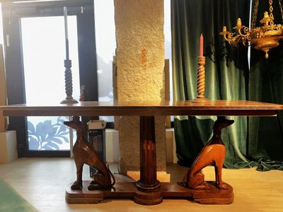 a wooden table with a bird on it in a living room