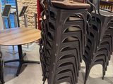 many chairs and tables in a room with a brick wall