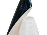 a white vase with a black and white design on it