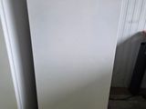 two white refrigerators in a room next to each other