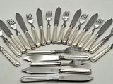 a lot of forks and knives that are on the table