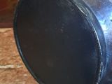 a black vase sitting on a marble counter top