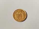 a close up of a gold coin on a white surface