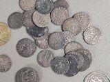 a lot of silver and gold coins on the table