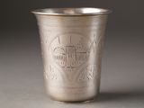 a silver cup with a design on it on a table