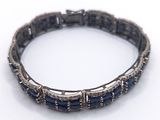 an image of a close up of a bracelet on a white surface